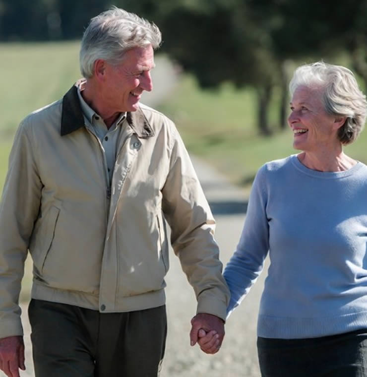 A smiling older couple taking a walk together